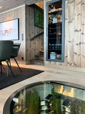 a room with a glass table in front of a building at Mountain Home On Høgevarde With Majestic Views in Flå