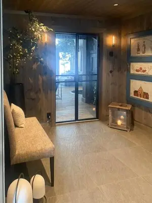 a living room with a chair and a glass door at Mountain Home On Høgevarde With Majestic Views in Flå