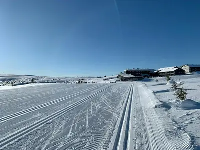 a road covered in snow with buildings in the background at Cosy Apartment With Ski Inout In Hafjell in Øyer