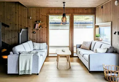 a living room with two couches and a table at Spacious Familyabin With A View On Norefjell in Noresund