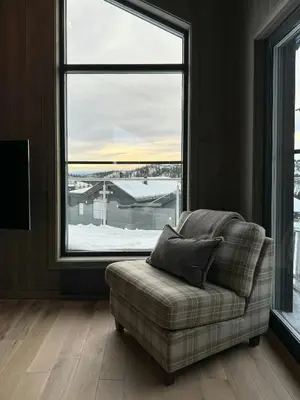 a couch in a room with a large window at Modern Family Cabin In Norefjell Ski-Inout in Surteberg