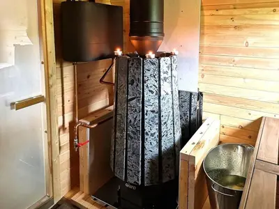 a small kitchen with a stove in a room at Mountain Cabin With Stunning Views, Sauna & Lake in Eggedal
