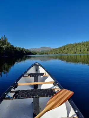 a boat sitting on a body of water at Mountain Cabin With Stunning Views, Sauna & Lake in Eggedal