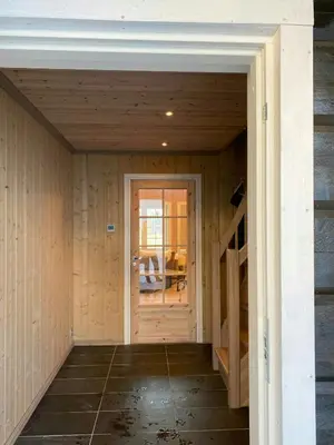 an empty room with a door and a staircase at Mountain Cabin With Sauna, Jacuzzi And Views in Nord Torpa