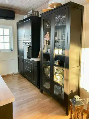 a kitchen with a black cabinet filled with dishes at Family Cabin With Views In Sør-Fron in Sør-Fron