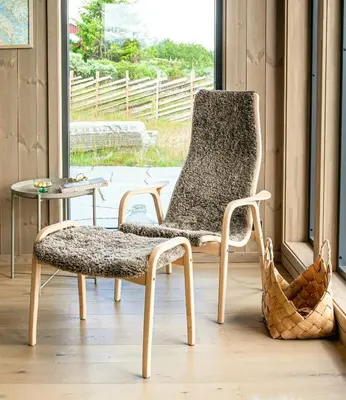 a chair and a table in a room at Modern Mountain Cabin With Nature In Valdres in Løken