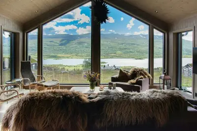 a living room with a large window with a view at Modern Mountain Cabin With Nature In Valdres in Løken