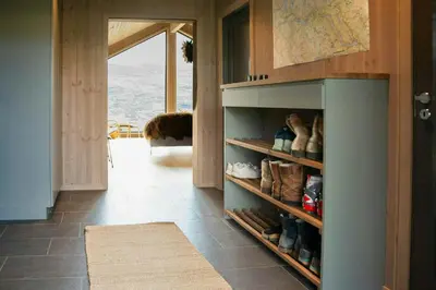 a room with a shelf with shoes on it at Modern Mountain Cabin With Nature In Valdres in Løken