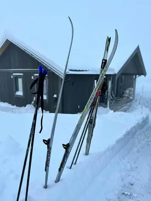 a group of skis and poles standing in the snow at Modern Mountain Cabin With Nature In Valdres in Løken