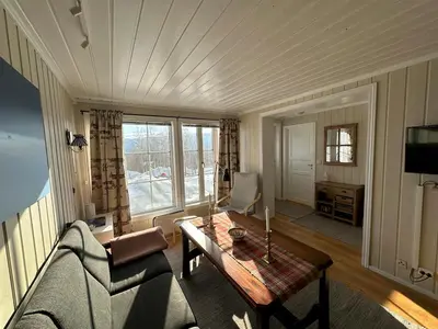 a living room with a couch and a table at Cozy Two Bedrooms Apartment With Sauna And Mountain Views in Beitostøl