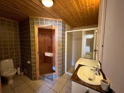 a bathroom with a shower and a sink and a toilet at Cozy Two Bedrooms Apartment With Sauna And Mountain Views in Beitostøl