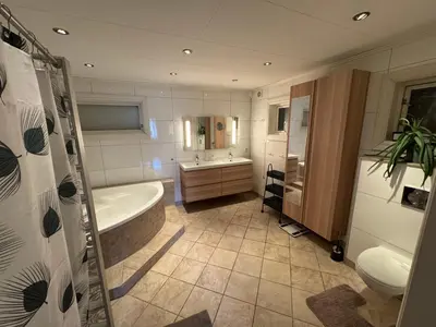 a bathroom with a tub and a sink at Lodge Orkanger - Spacious Comfort - Designed for family moments in Orkanger
