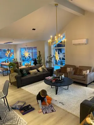 a child playing with a rug in a living room at Lodge Orkanger - Spacious Comfort - Designed for family moments in Orkanger