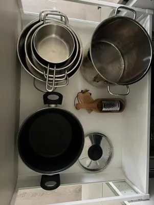three pots and pans hanging from a wall in a kitchen at Lodge Orkanger - Spacious Comfort - Designed for family moments in Orkanger