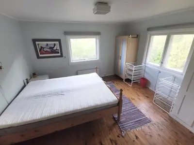 a bedroom with a large bed and two windows at Hemsedal - 5 bedrooms in Fausko