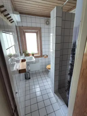 a bathroom with a tub and a sink and a toilet at Hemsedal - 5 bedrooms in Fausko