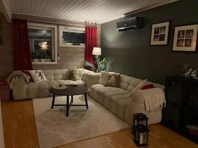 a living room with a couch and a table at Utsikten in Trondheim