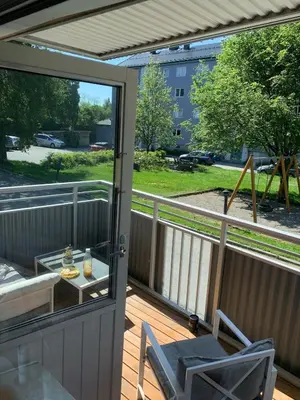 a balcony with a glass door and a table and chairs at Central 4-bedroom by Lerkendal in Trondheim