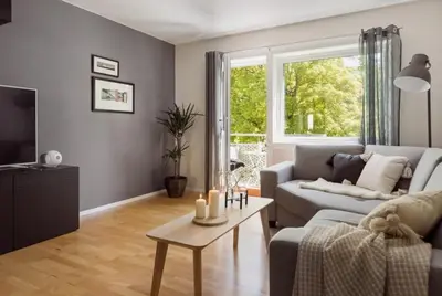 a living room with a couch and a table at Sentral leilighet Trondheim in Trondheim