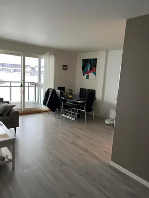 a living room with a table and chairs in it at Ski VM in Trondheim