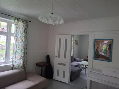a living room with a couch and a chandelier at Jordamorstova in Aurland