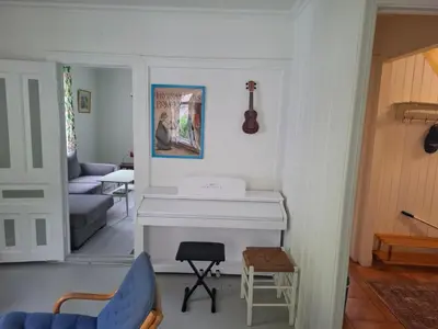 a living room with a white fireplace and a blue chair at Jordamorstova in Aurland