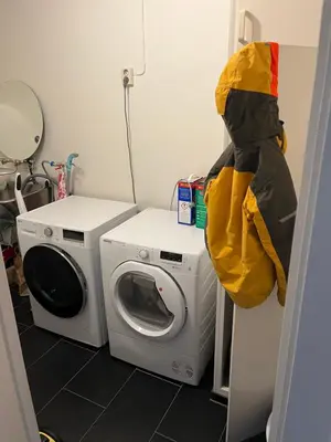 a laundry room with a washing machine and a washer at Trondheim in Trondheim