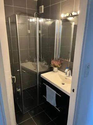 a bathroom with a shower and a sink and a mirror at Trondheim in Trondheim