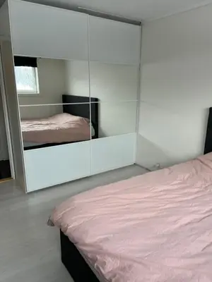 a bedroom with a mirror and a bed in it at Trondheim in Trondheim