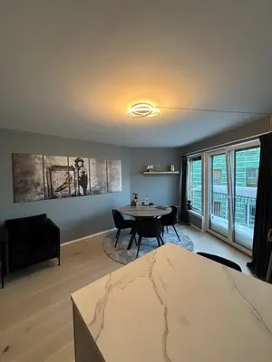 a living room with a table and a couch at Penthouse in Trondheim, Solsiden in Trondheim