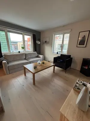 a living room with a couch and a coffee table at Penthouse in Trondheim, Solsiden in Trondheim
