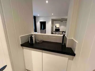 a kitchen with a counter top and a mirror at Apartment by Torgalmenningen in Bergen