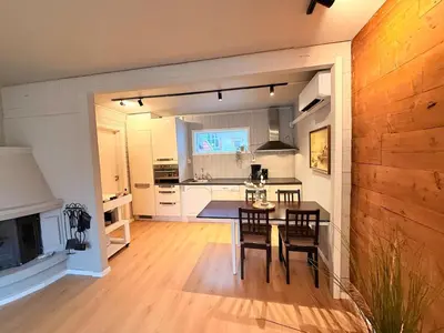 a kitchen and dining room with a table and chairs at Live the history in Bergens heart - Stay unique in Bergen