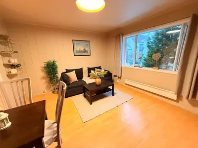 a living room with a couch and a table and a window at Live the history in Bergens heart - Stay unique in Bergen