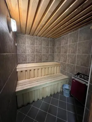 a sauna with a bench in a tiled room at Voss Apartment in Oppheim Resort, pool and view in Vossevangen