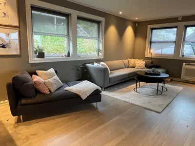 a living room with a couch and a table at Enebolig til utleie in Trondheim