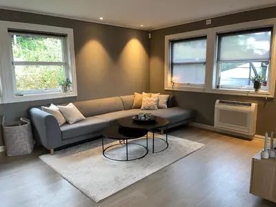 a living room with a couch and a table at Enebolig til utleie in Trondheim