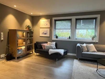 a living room with a couch and a chair at Enebolig til utleie in Trondheim
