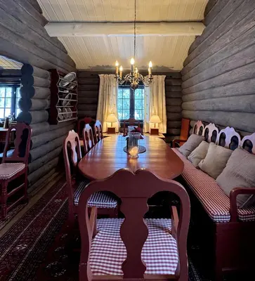 a dining room with a table and a couch at Large, cozy, and spacious cabin in Geilo in Geilo