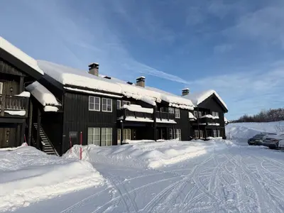 a building covered in snow with a lot of snow at Family-Friendly Apartment In Central Beitostølen in Beitostøl