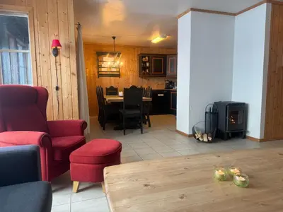 a living room with a table and a stove at Family-Friendly Apartment In Central Beitostølen in Beitostøl