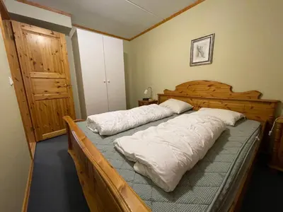 a bedroom with a wooden bed with two pillows at Family-Friendly Stay Near Ski Trails! in Beitostøl