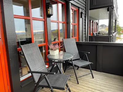 a patio with two chairs and a table on a balcony at Family-Friendly Stay Near Ski Trails! in Beitostøl