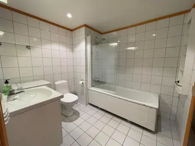 a bathroom with a tub and a toilet and a sink at Family-Friendly Stay Near Ski Trails! in Beitostøl