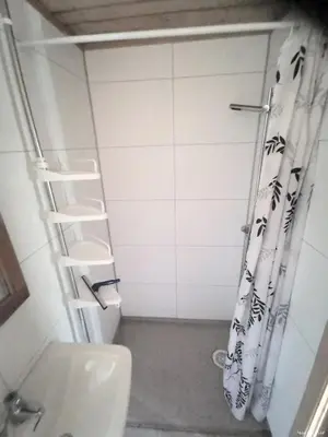 a bathroom with a shower curtain and a toilet at Hemsedal - 7 bedrooms - WI-FI in Hemsedal