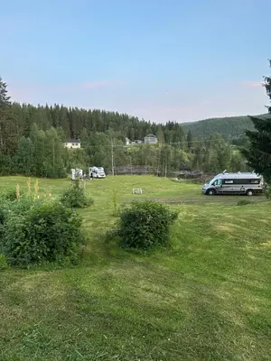 a field with a van parked in a field at Turifoss Camping Tent pitch in Svedjan
