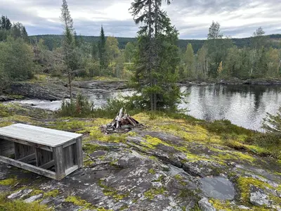 a bench on the rocks near a body of water at Turifoss Camping Tent pitch in Svedjan