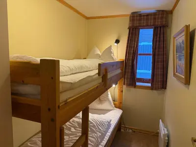 two bunk beds in a room with a window at Homey Apartment Steps From Dining And Activities! in Beitostøl