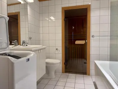 a bathroom with a toilet and a sink and a shower at Homey Apartment Steps From Dining And Activities! in Beitostøl