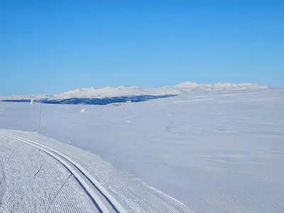 a road in the middle of a snow covered field at Varden in Sør-Fron
